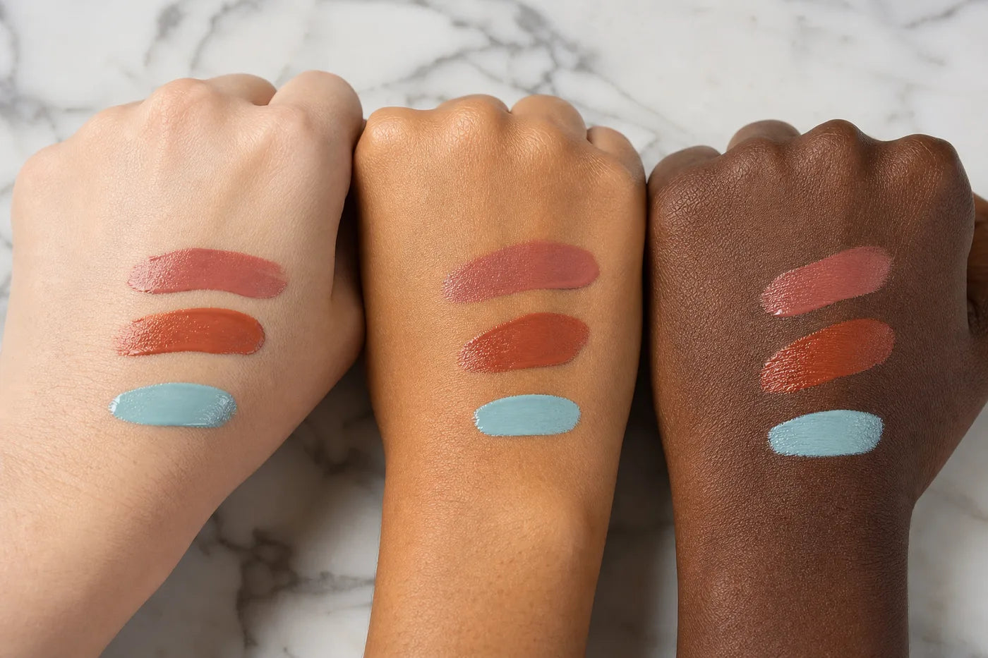 Cosmetic swatches on three different skin tones